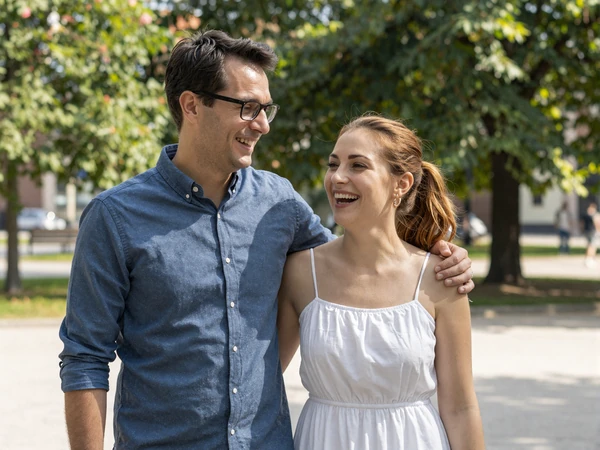 James and Anna sharing a happy moment in the park after meeting through our platform